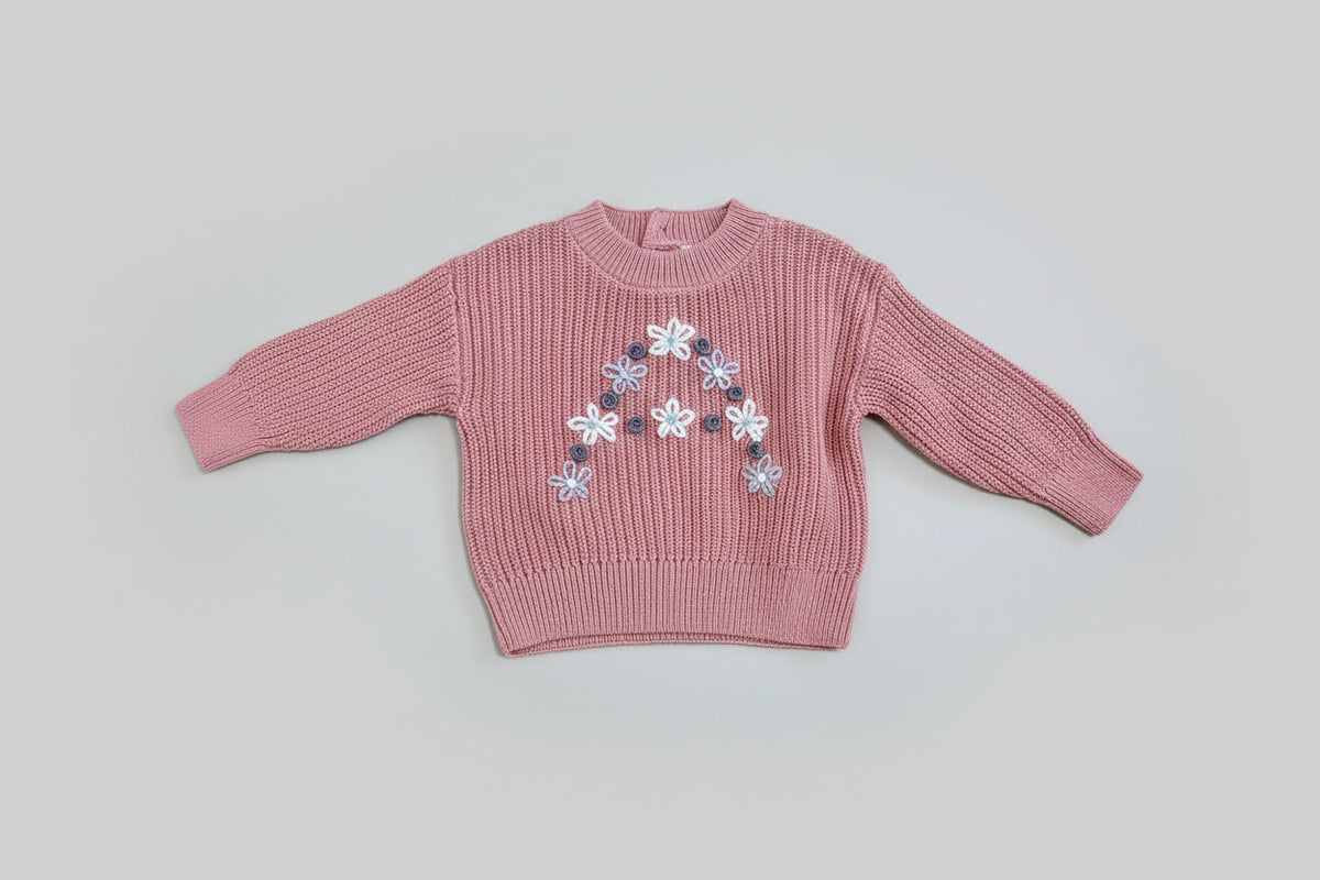 Pink sweater with a floral design 